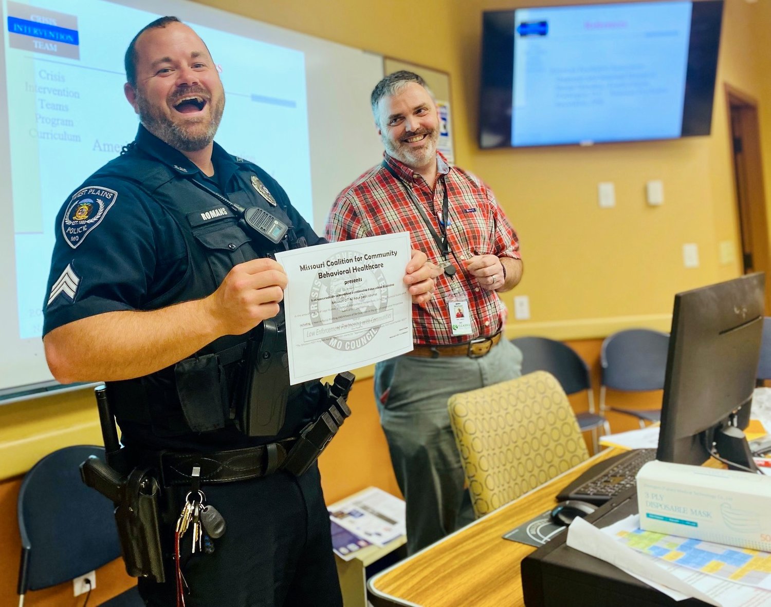 West Plains Police Patrol Sgt. Brandon Romans, left, is pictured accepting his certificate of completion of the Ozarks Healthcare BHC’s most recent CIT training as Community Behavioral Health Liaison Michael Lewis looks on.